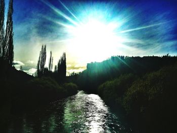 Scenic view of landscape against bright sun