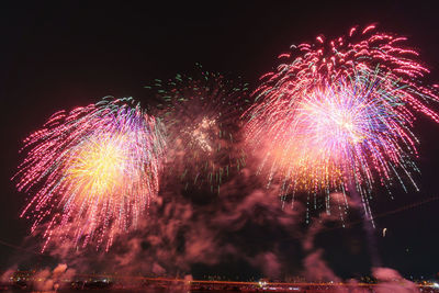 Low angle view of firework display at night