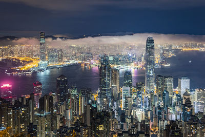 Aerial view of illuminated city and buildings against sky