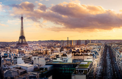Eiffel tower seen amidst buildings against sky in city