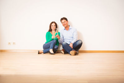 Portrait of a smiling young couple sitting at home