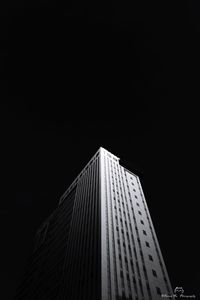 Low angle view of illuminated buildings against clear sky at night