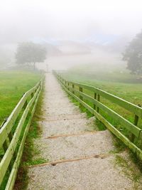 Scenic view of landscape against sky during foggy weather