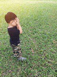 High angle view of boy standing on field