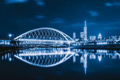 View of illuminated bridge and buildings at night