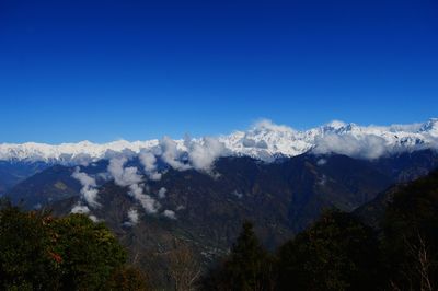 Scenic view of mountains against clear blue sky