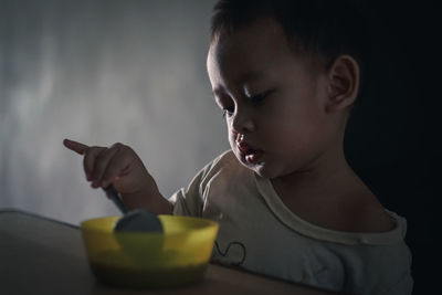 Portrait of boy holding ice cream at home