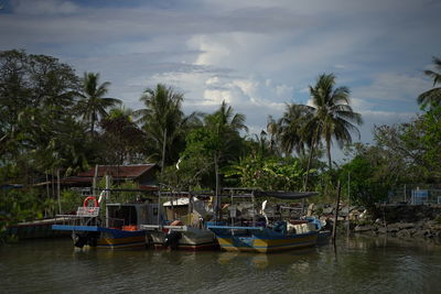 Boats moored in sea against sky