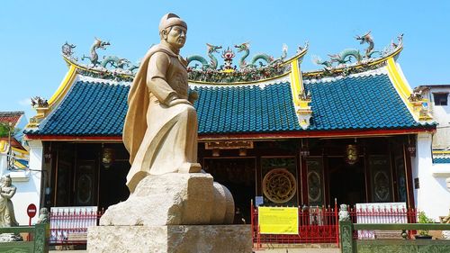 Low angle view of statue against building