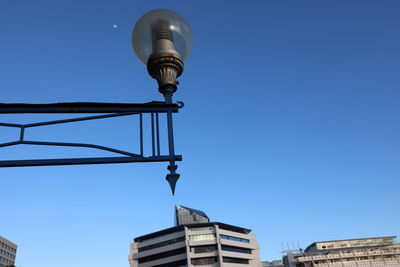 Low angle view of street light against building