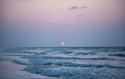 Scenic view of sea against sky during sunrise