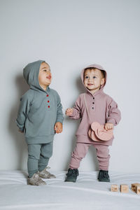 Baby fashion. unisex clothes for babies. two cute baby girls or boys in cotton set