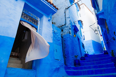 Low angle view of alley amidst building