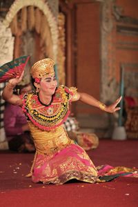 Man in traditional clothing performing during event