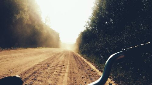 Road amidst trees against clear sky