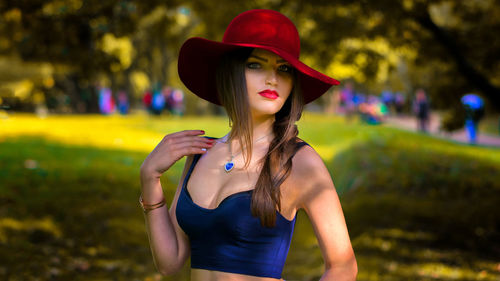 Portrait of sensuous beautiful woman wearing hat at park