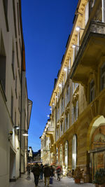 Low angle view of buildings against clear blue sky