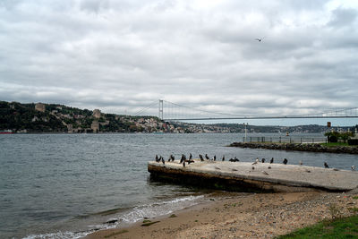 View of bridge over river against cloudy sky