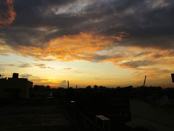 Silhouette buildings against sky during sunset