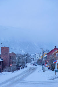 Snow covered landscape against clear sky