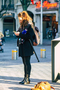 Rear view of woman walking on street in city