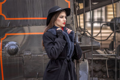 Portrait of young woman standing in factory