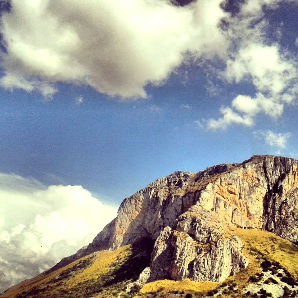 mountain, sky, scenics, tranquil scene, tranquility, mountain range, beauty in nature, cloud - sky, landscape, nature, cloud, physical geography, cloudy, rocky mountains, non-urban scene, geology, rock formation, rock - object, idyllic, low angle view