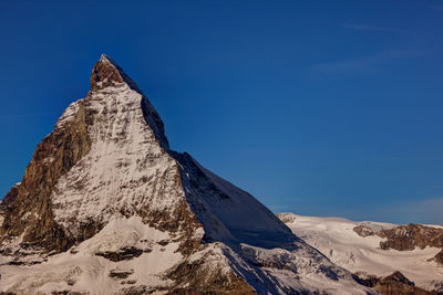 Scenic view of snow covered mountains against sky