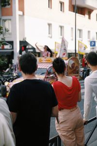 Rear view of people standing on street