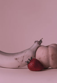 High angle view of fruits against pink background