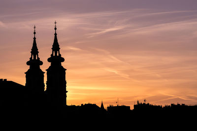 Low angle view of silhouette building during sunset