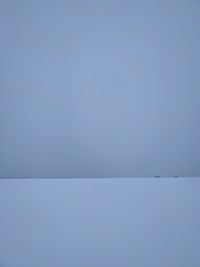 Scenic view of snow against clear blue sky