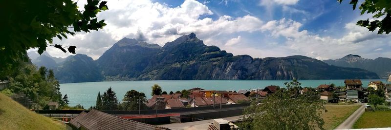 Panoramic view of sea and mountains against sky