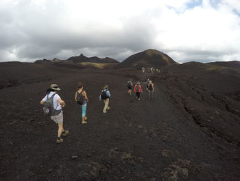 People walking on barren landscape