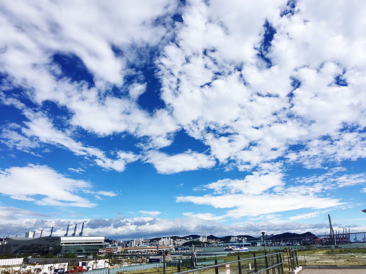 built structure, sky, architecture, building exterior, cloud - sky, cloud, blue, city, day, cloudy, outdoors, cloudscape, town, residential district, development, no people, scenics, city life