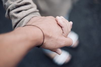 Cropped image of people holding hands