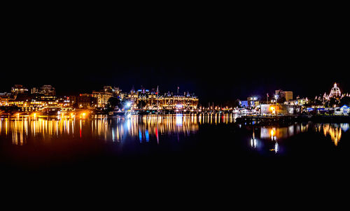 Reflection of illuminated buildings in water at night