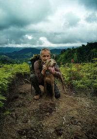 Dog on plants against sky