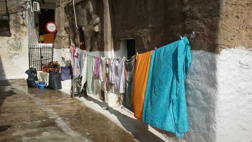 Clothesline against house in town on sunny day