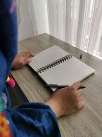 High angle view of woman reading book at home