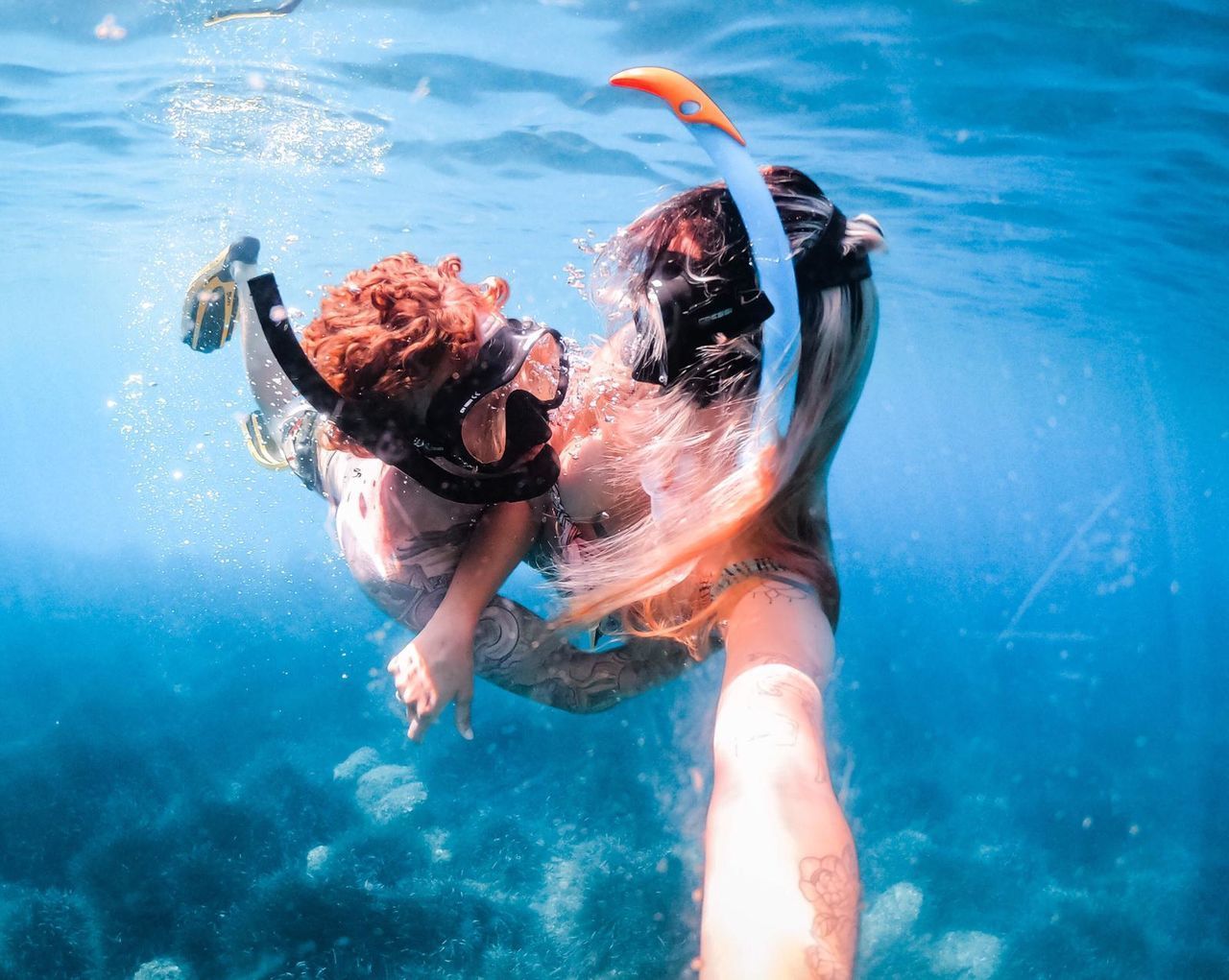 MIDSECTION OF WOMAN SWIMMING IN POOL