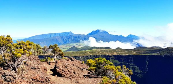 Scenic view of mountains against clear blue sky