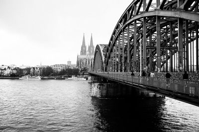 Hohenzollern bridge over rhine river in city against sky