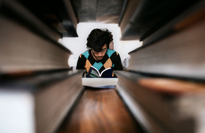 Full length of woman sitting on book