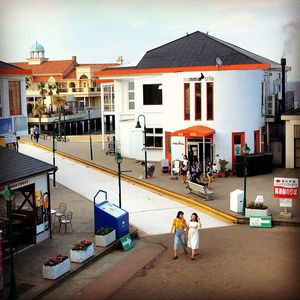 People on street amidst buildings in city