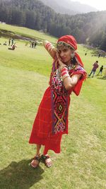 Portrait of woman standing on field