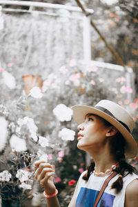 Young woman looking at flowering plants