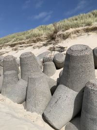 Stack of rocks on beach against sky