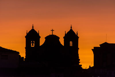 Silhouette of church against sky during sunset