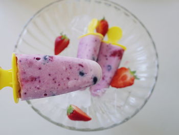 Close-up of yogurt popsicle over gray background